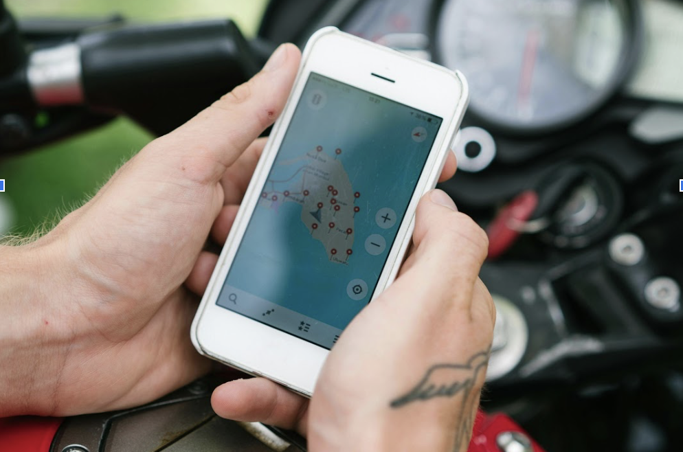 Hands holding a smartphone showing a map.
