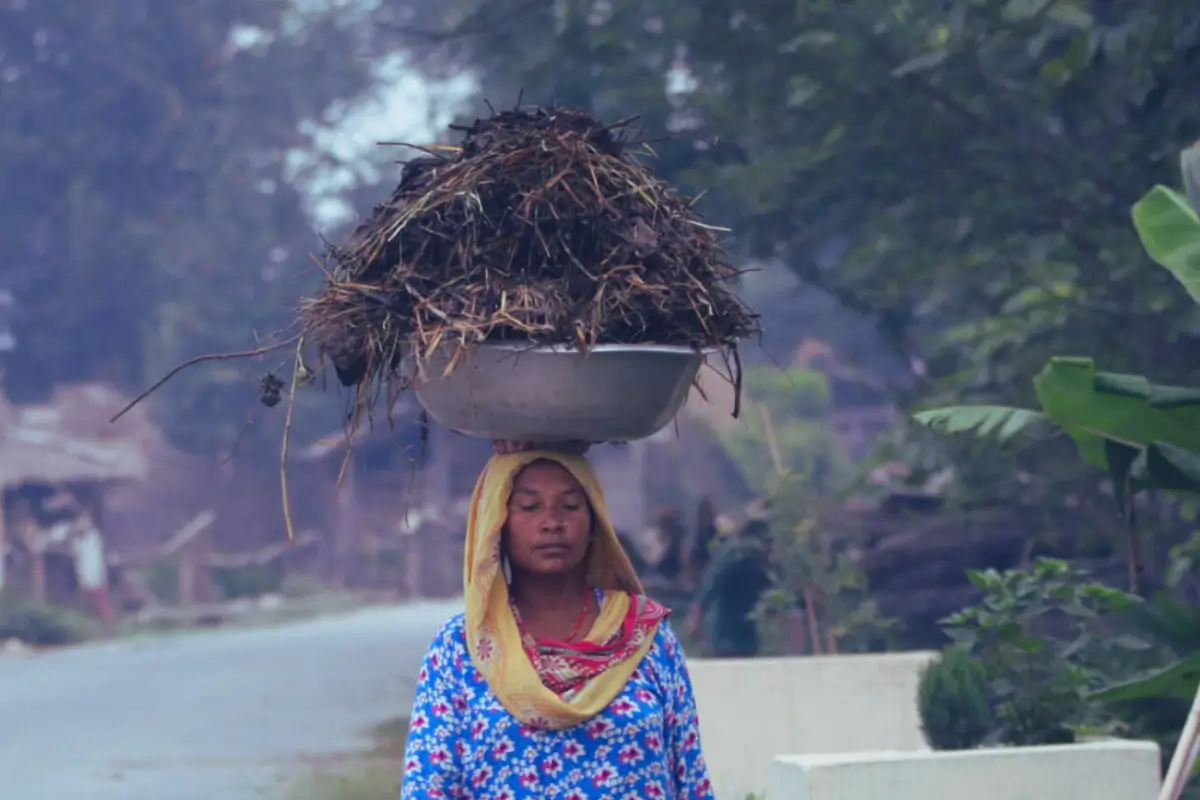 A woman member of the Buffer zone community in Chitwan walks on the road.